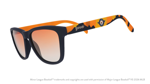 Angled view of shades tilted down. Blue frames w/ an orange+yellow landscape, Aviators logo+orange gold gradient lenses.