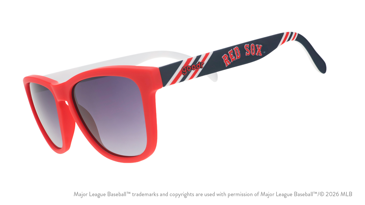Three-quarter angle view of a pair of red, white, and navy sunnies featuring the Red Sox's team name logo on the arm.