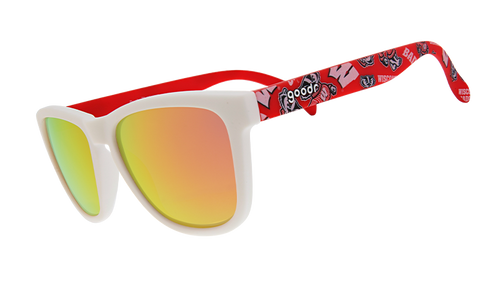 A pair of "goodr" sunglasses with white frames and reflective orange-gold lenses. The arms of the sunglasses are red and feature the University of Wisconsin’s mascot, Bucky Badger, along with bold "W" logos and other school-themed graphics.