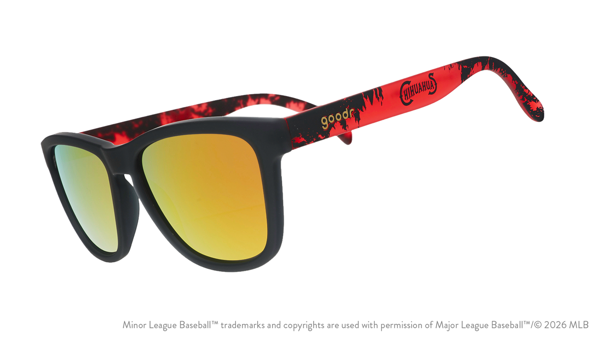 Angled view of shades tilted down. Dark gray+red frames w/ Chihuahuas on temples. Amber reflective lenses.