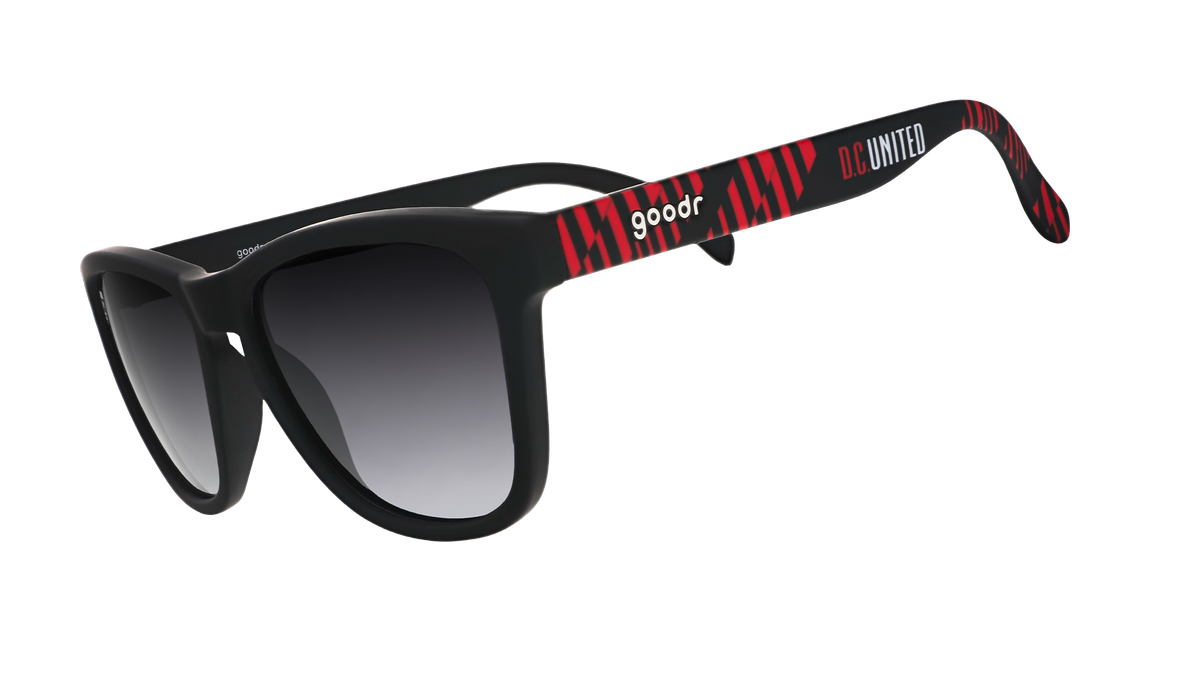 Three-quarter angle view of DC United Major League Soccer sunglasses with black and red frames and black lenses.