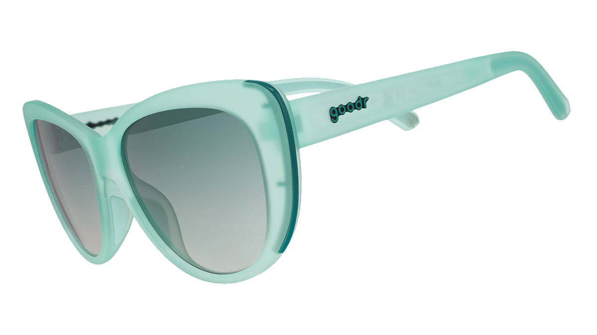 Three-quarter angle view of translucent pale green Glam G cat-eye sunglasses with  green gradient lenses.