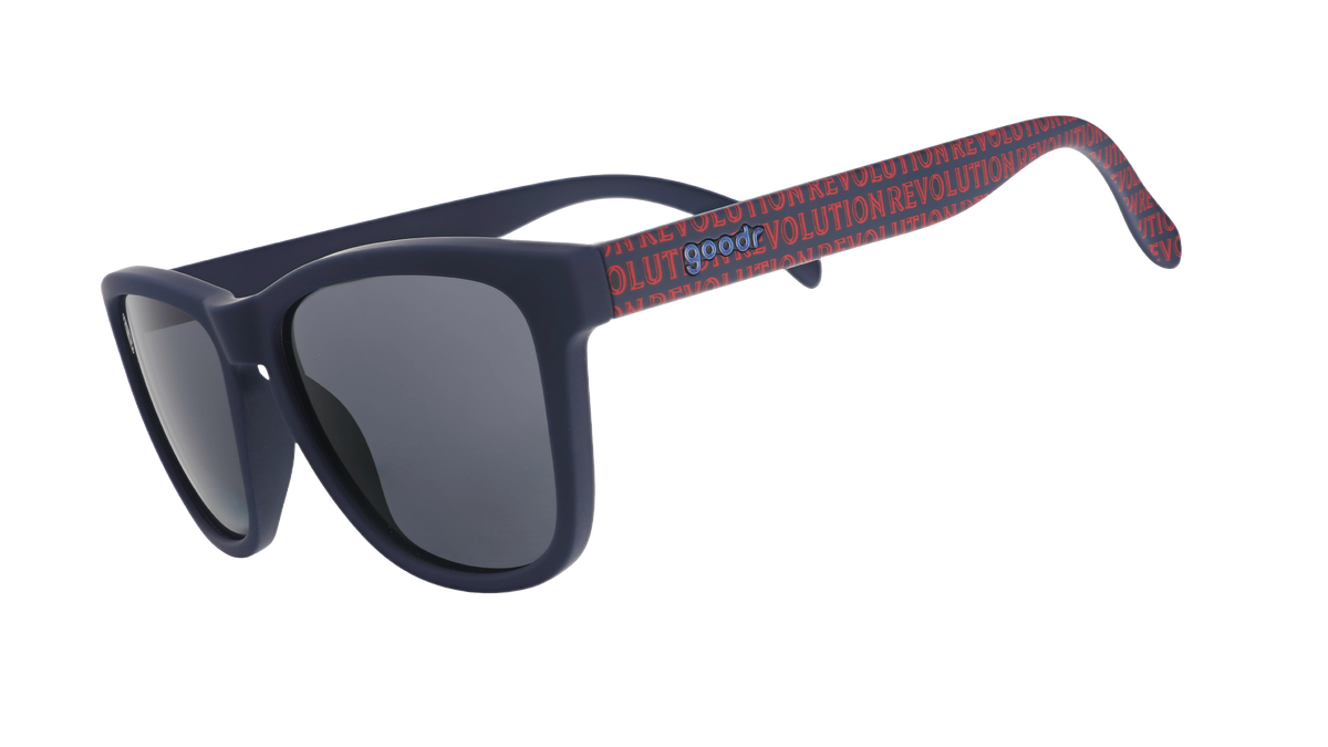 Three-quarter angle view of MLS New England Revolution shades tilted down. Black+red frames. Black non-reflective lenses.