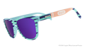 Side view of Crayola goodr UV-activated sunglasses with green and purple frames and purple reflective lenses.