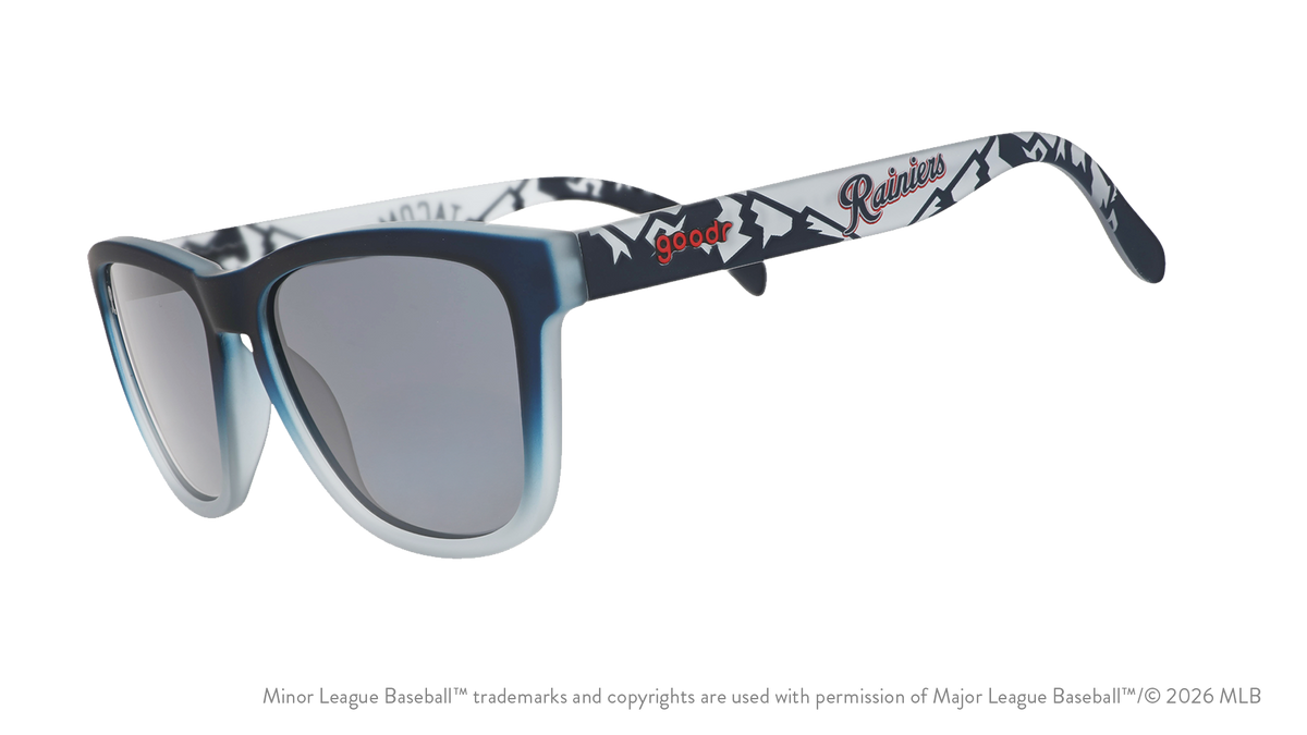 Three-quarter angle view of shades. Gray frames w/ mountain pattern, Rainiers on temples + black non-reflective lenses.