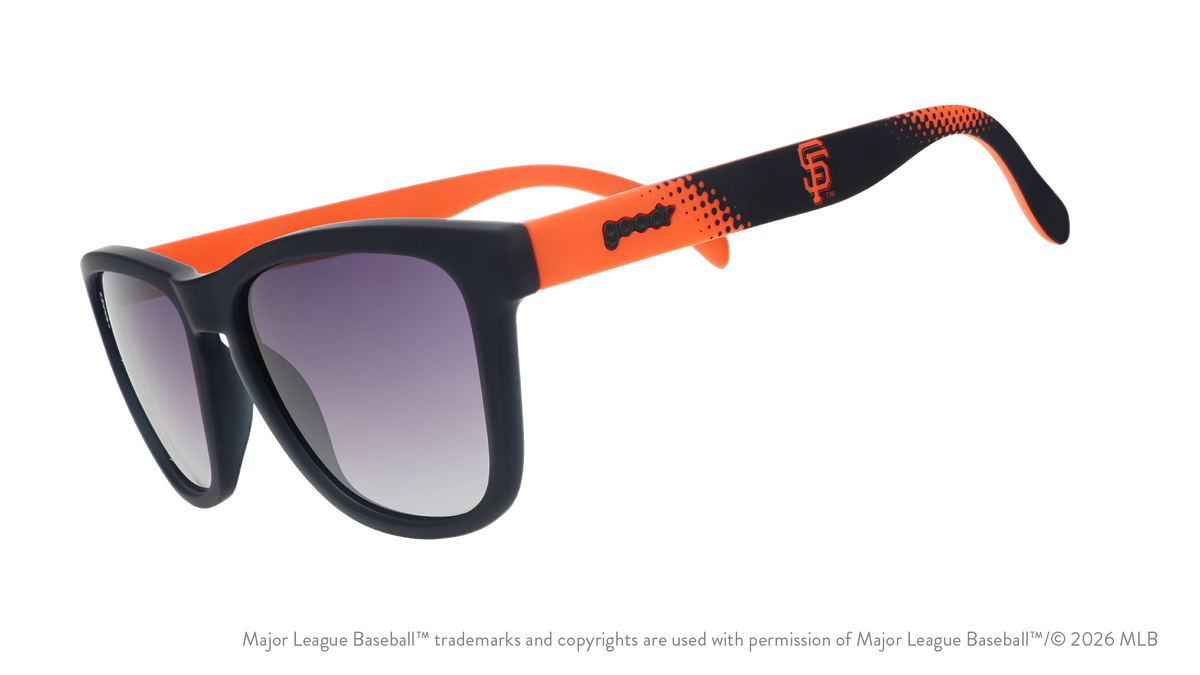 Three-quarter angle view of a pair of black and orange Giants sunglasses featuring the SF logo on the arm.