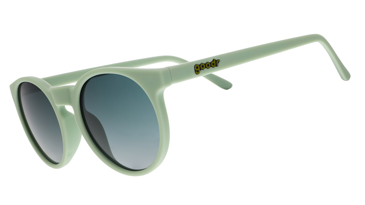 A pair of round sunglasses with mint green frames.