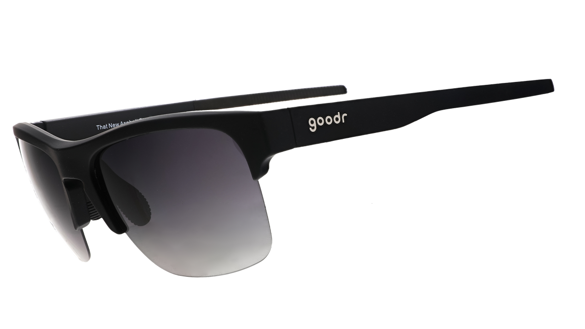 Three-quarter angle view of black half-rim sunglasses with a dual-lens wrap and polarized black gradient lenses and black silicone grips on the inner right arm.