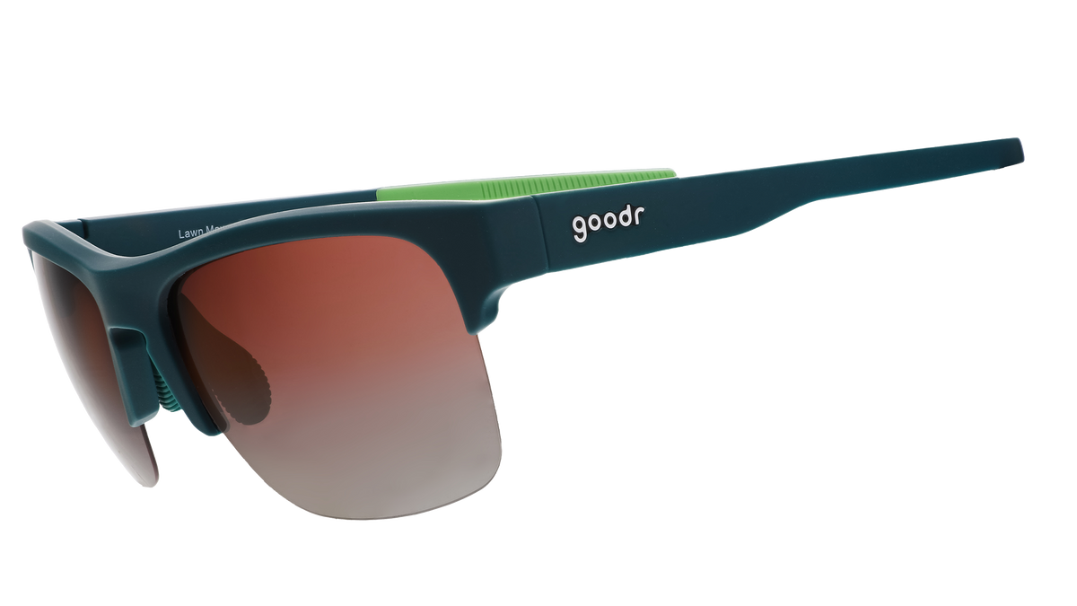 Three-quarter angle view of solid green half-rim sunglasses featuring polarized rose gradient lenses and lime green silicone grips on the inner right arm.