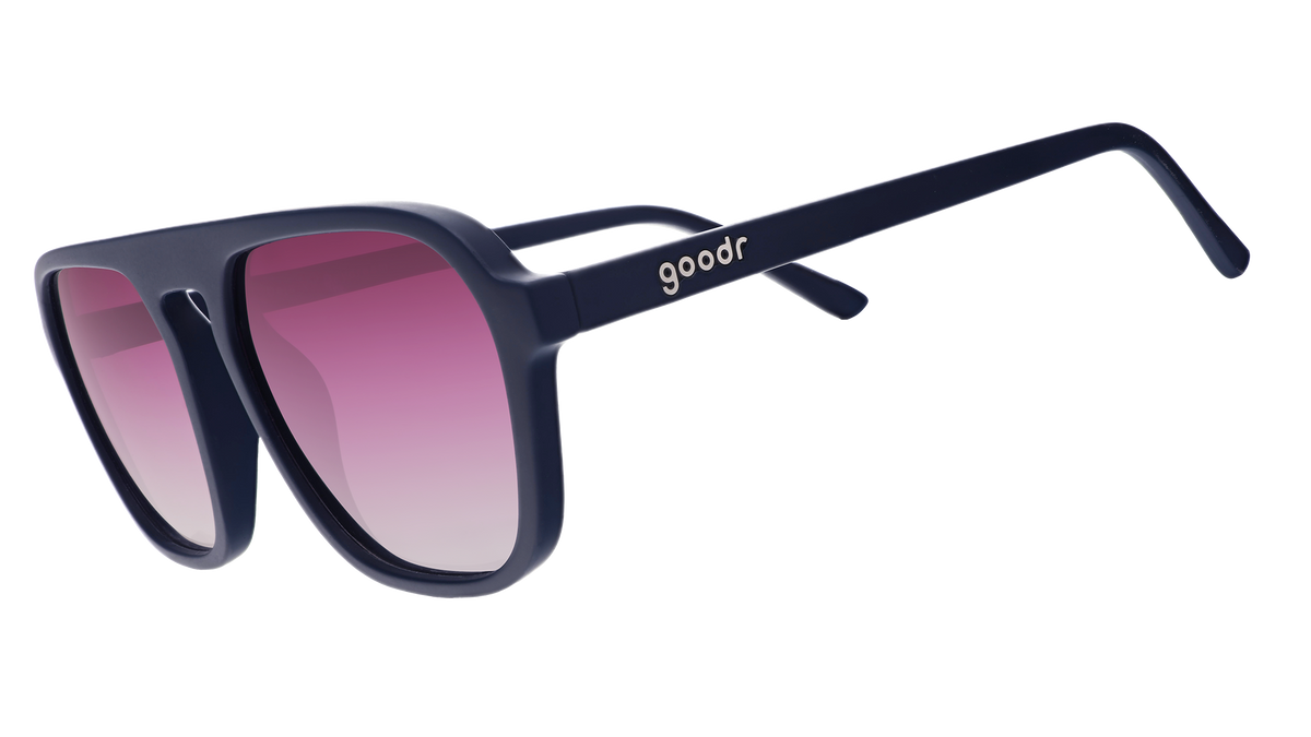 A pair of dark blue goodr sunglasses with gradient pink lenses, on a white background.