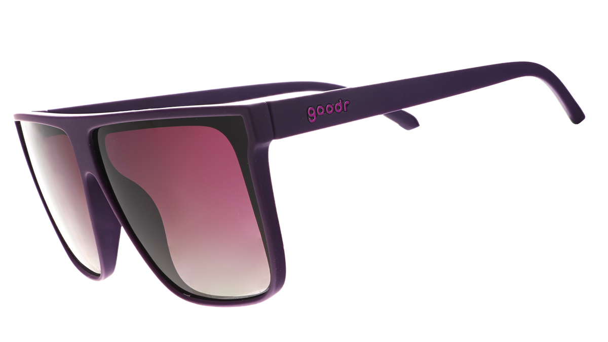 Three-quarter angle view of oversized, dark purple flat-top sunglasses with deep purple gradient lenses.