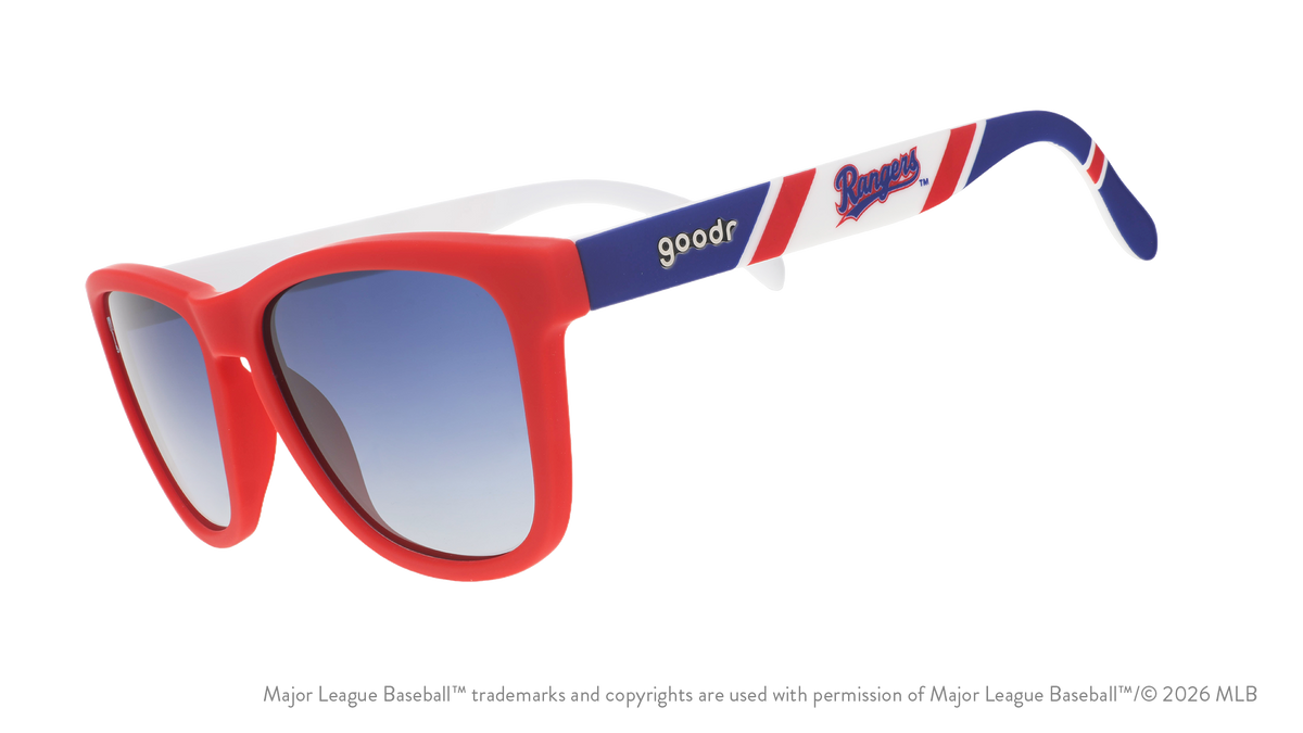 Three-quarter angle view of a pair of red, white, and blue sunglasses featuring the Texas Rangers logo on the arm. 