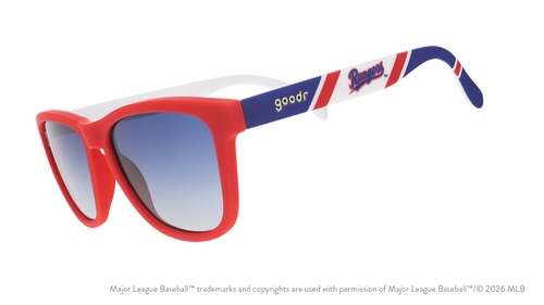 Three-quarter angle view of a pair of red, white, and blue sunglasses featuring the Texas Rangers logo on the arm. 