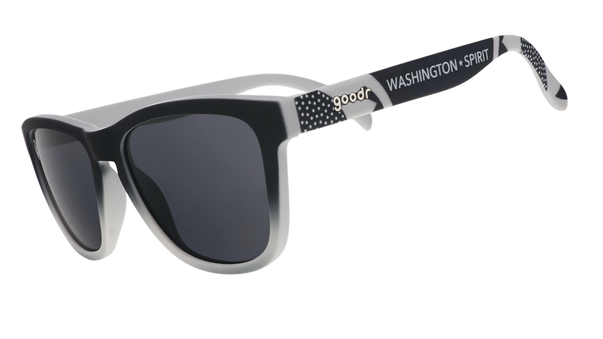 Three-quarter angle view of black and gray gradient sunglasses featuring black polarized lenses and the Washington Spirit logo.