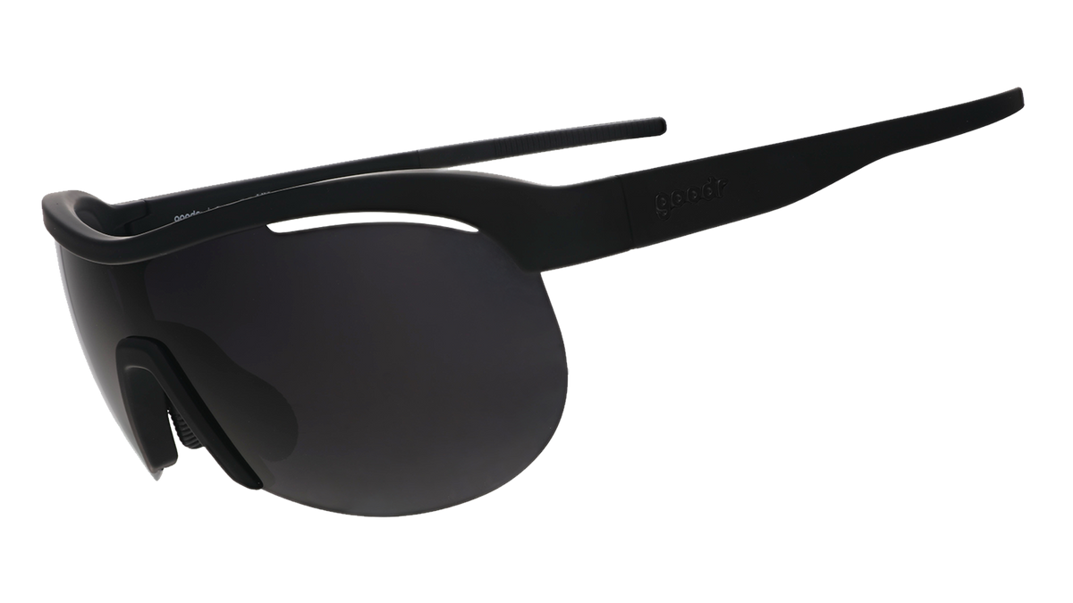 Three-quarter angle view of black wrap shield sunglasses with black polarized lenses against a white background.