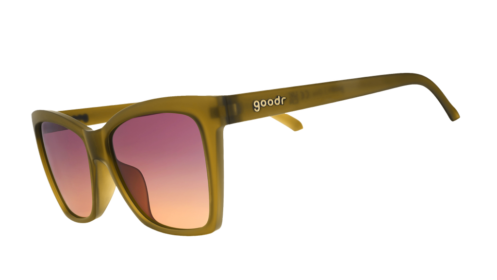 Three-quarter-angle view of translucent ochre angular cat-eye Pop Gs with purple-yellow gradient lenses.