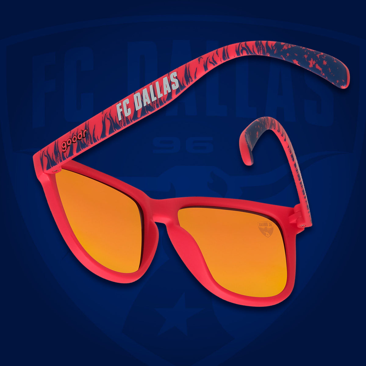 Back view of sunglasses tilted down. Red frames w/blue flames+FC Dallas on temples. Amber reflective lenses.