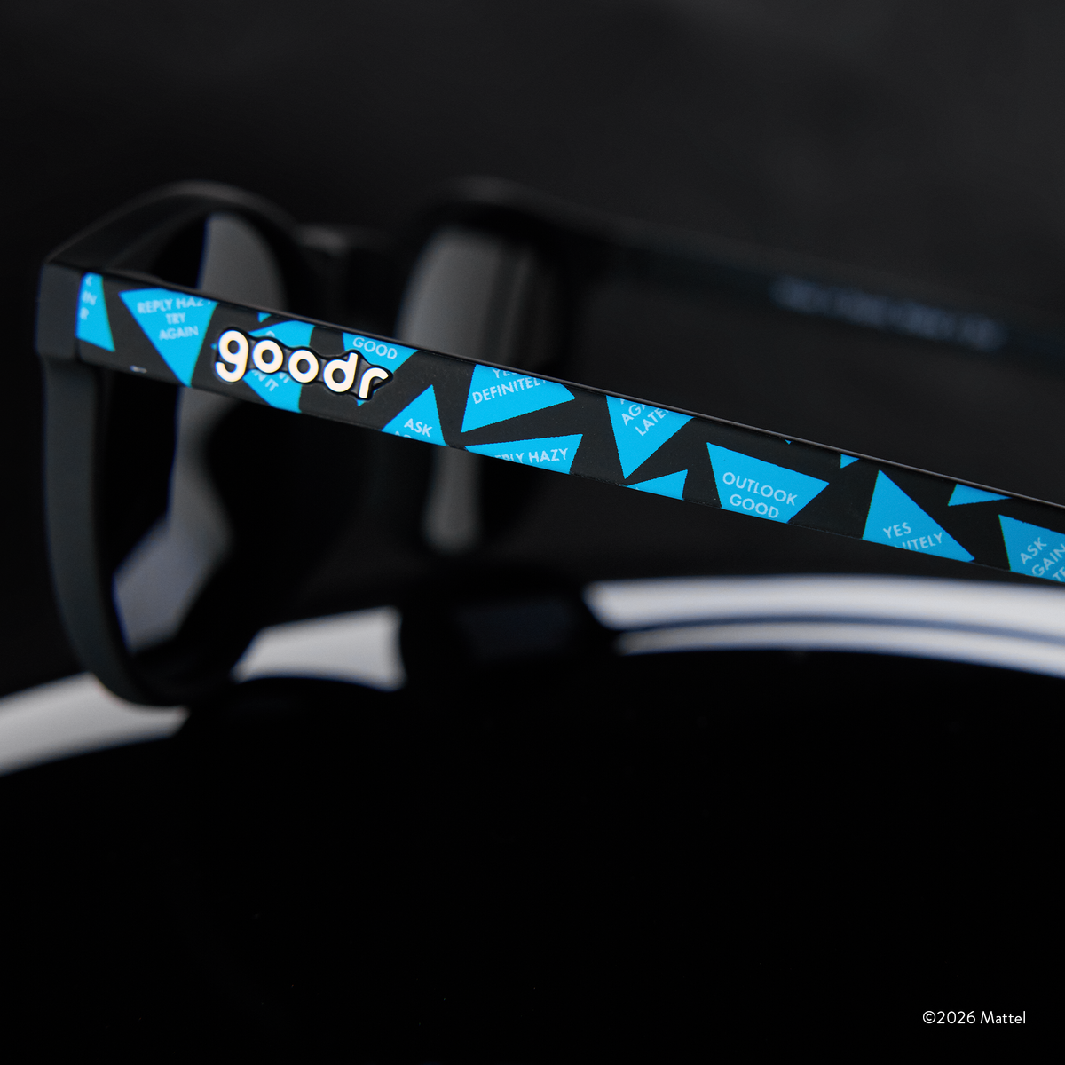 Close-up of sunglasses arm featuring a classic Magic 8 Ball design showcasing the ball's iconic fortune-telling responses