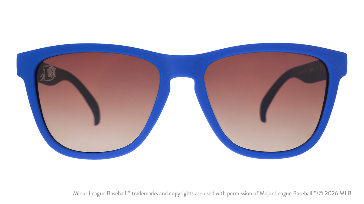 Front view of sunglasses. Blue front frame. Brown gradient lenses. Durham Bulls logo etching in top corner of lens.