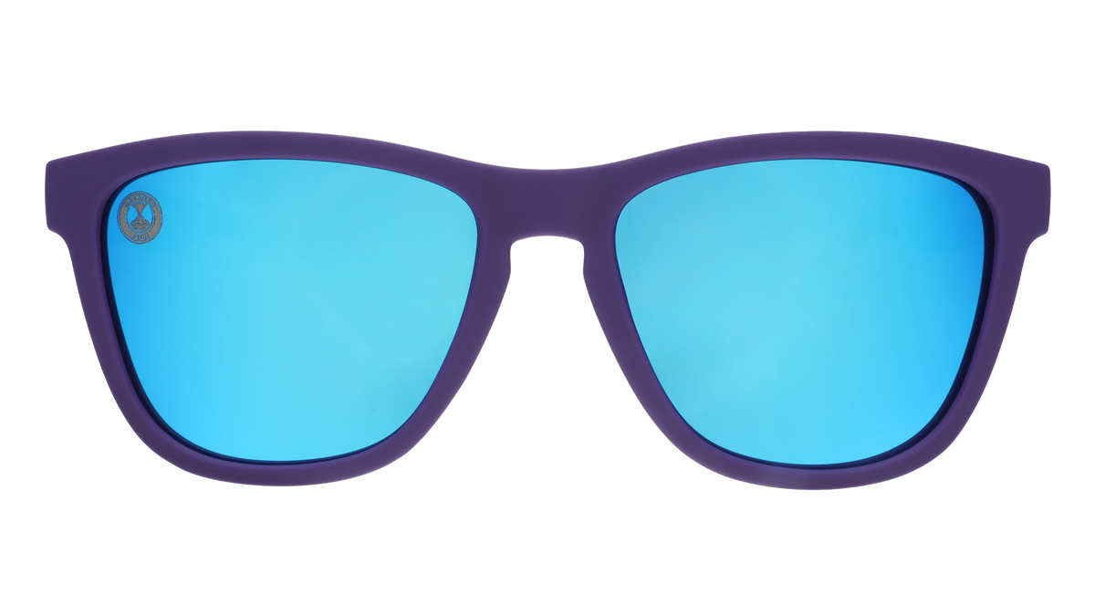 Sunglasses with blue lenses and purple frame on a white background