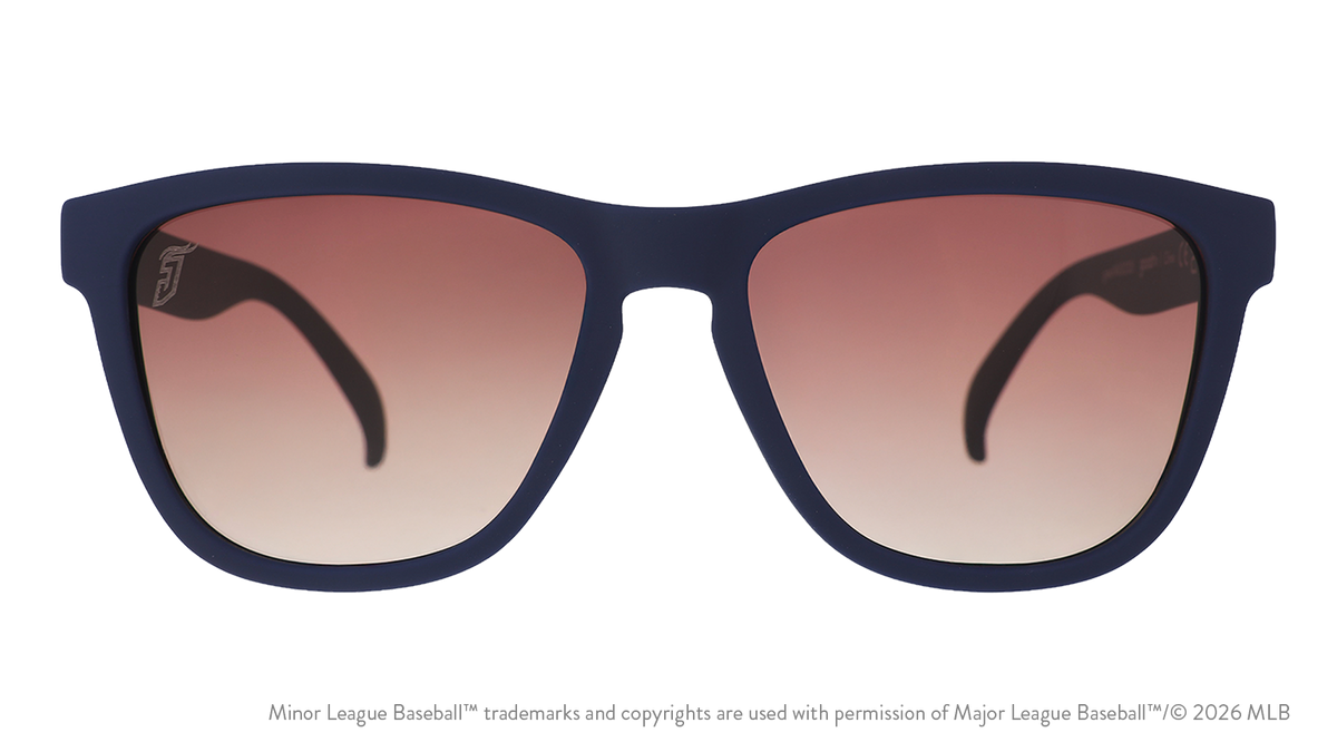 Front view of sunglasses. Blue front frame. Brown gradient lenses. Jumbo Shrimp logo etching in top corner of lens.