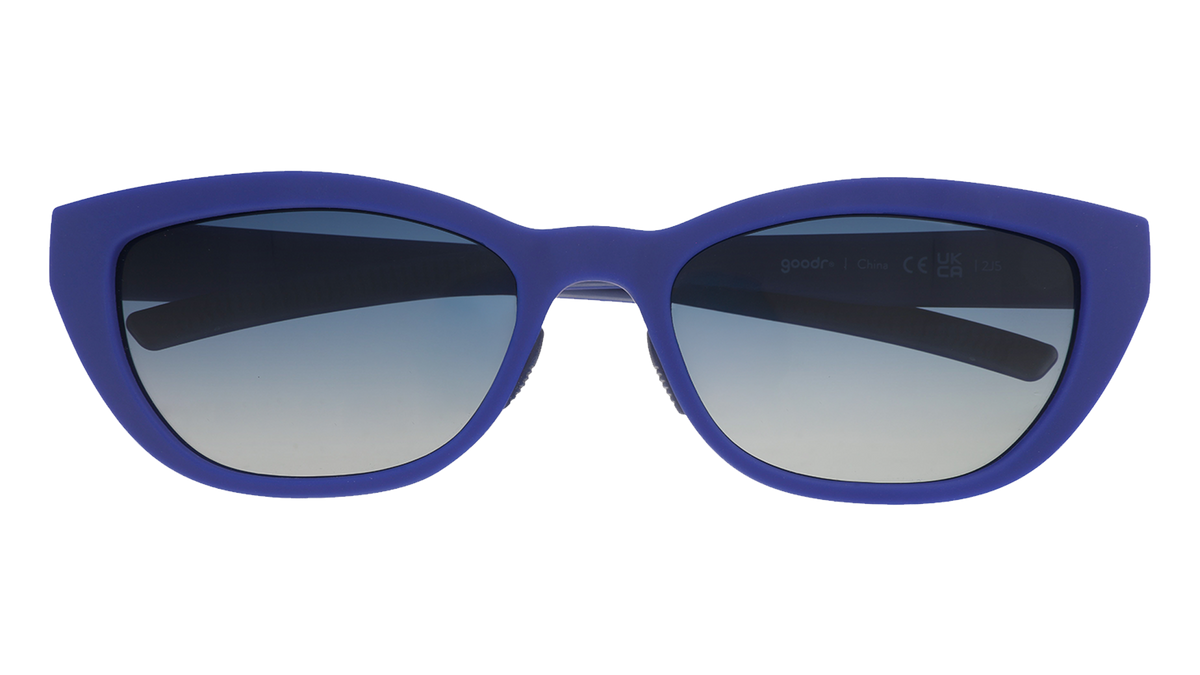 Front view of cat eye sunglasses. Navy blue front frame with blue gradient lenses on a white background.