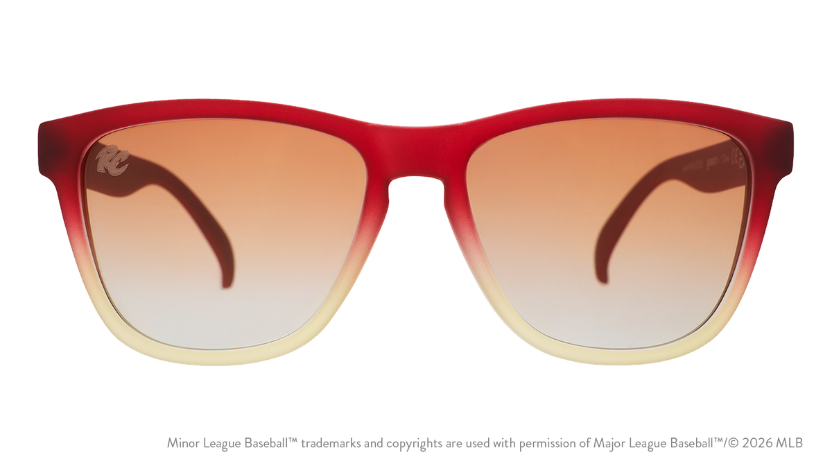 Front view of sunglasses. Red + brown front frame. Amber gradient lenses. River Cats logo etching in top corner of lens.
