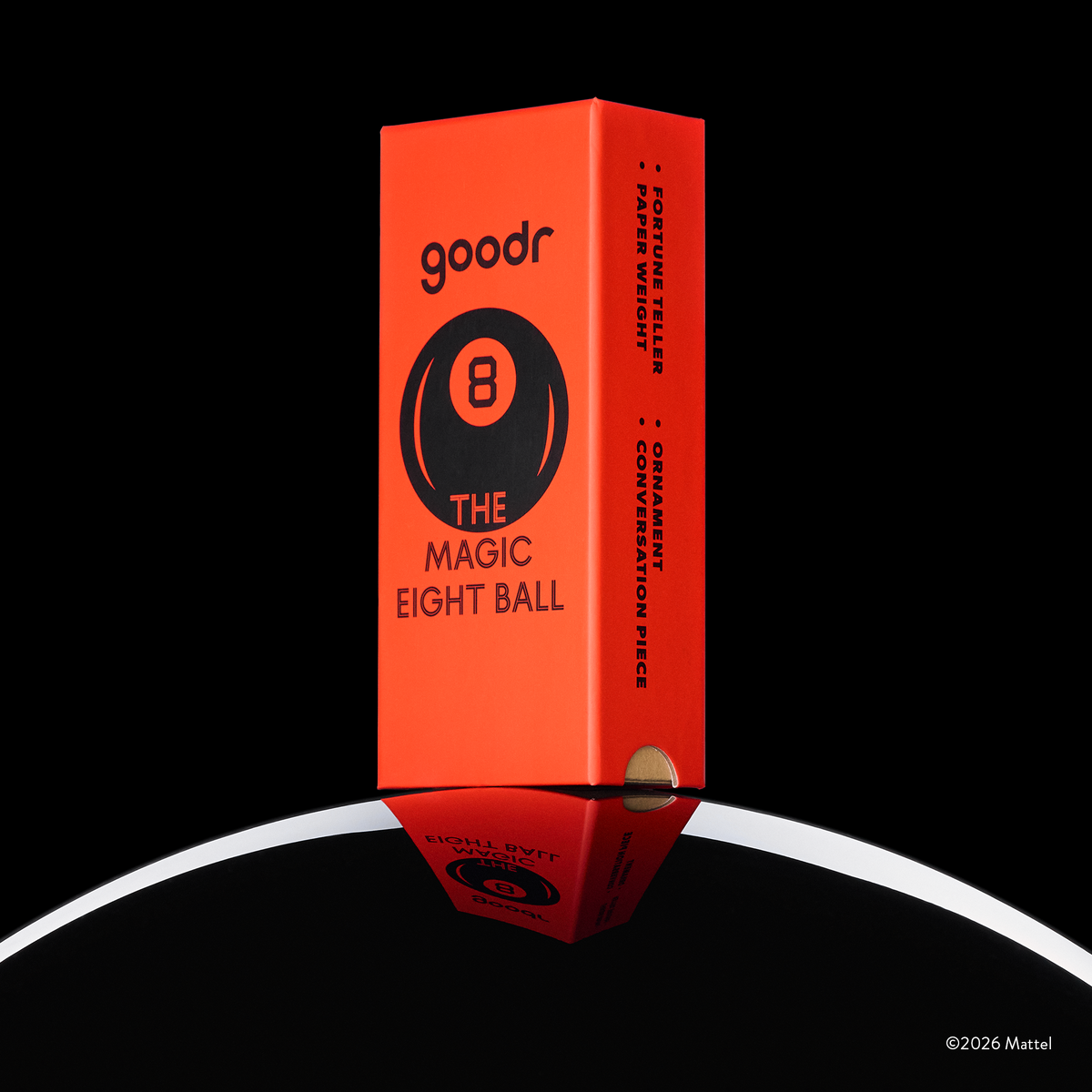A custom, vintage-inspired, red Magic 8 Ball-themed goodr sunglasses box is shown perched atop the curve of an 8 ball.