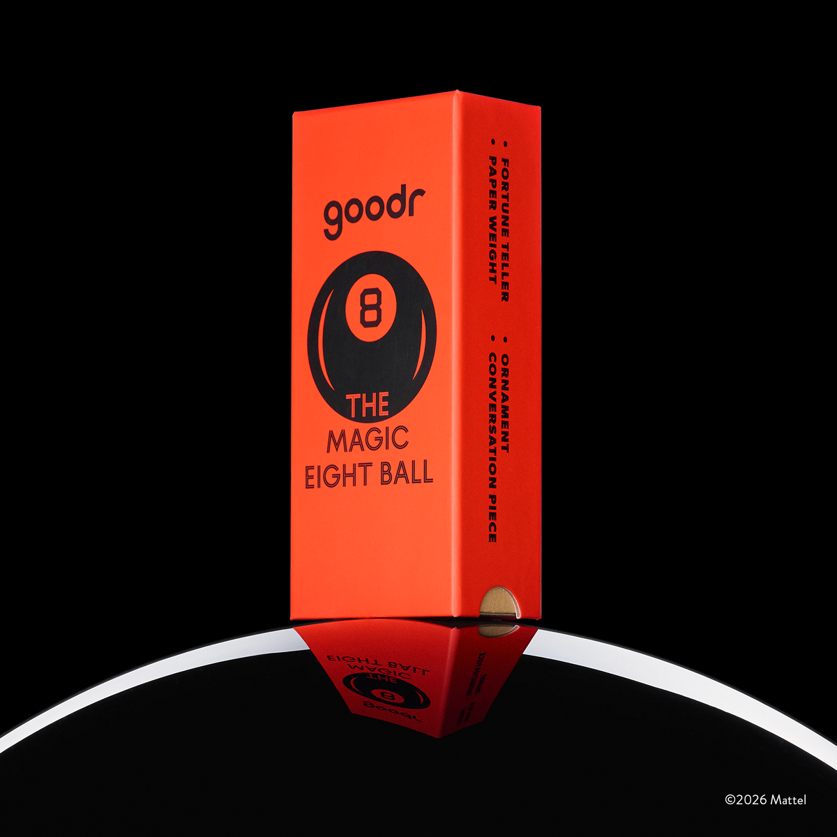 A custom, vintage-inspired, red Magic 8 Ball-themed goodr sunglasses box is shown perched atop the curve of an 8 ball.