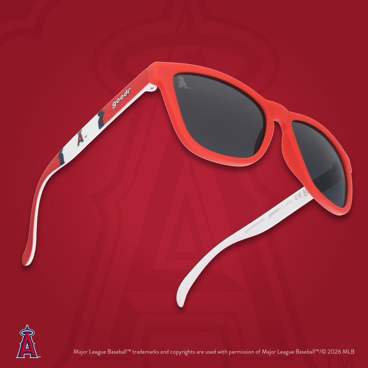 Three-quarter angle view of Angels sunglasses floating against a red background featuring the team's "halo A" logo.