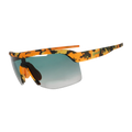 Sport sunglasses with a vibrant orange, yellow, and black camouflage pattern on the frame and arms, featuring a green-to-gray gradient lens and a small green 'goodr' text logo on the temple.