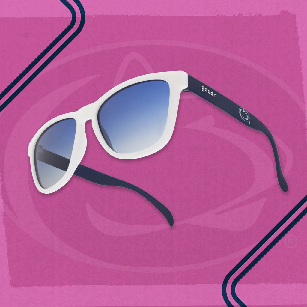 Penn State goodr sunglasses with a white frame and blue gradient lenses on a pink background.