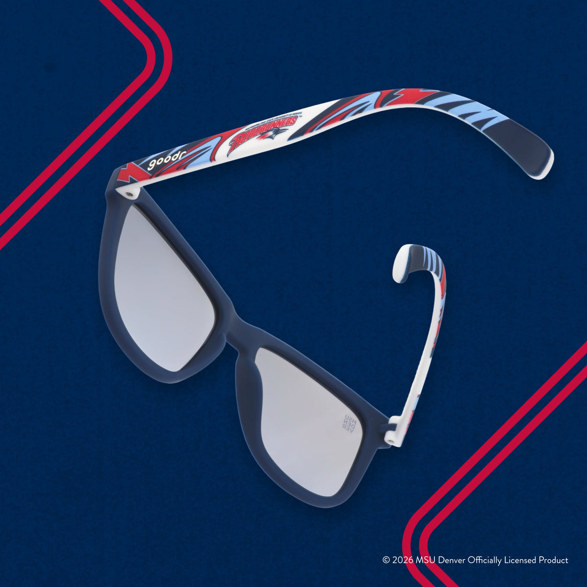 Back view of sunglasses tilted down. Solid blue frames w/ a red + white Roadrunners pattern + blue reflective lenses.